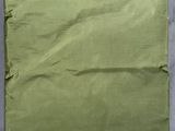 a close up of a piece of green fabric on a gray surface