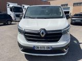 the front view of a white van parked in a parking lot