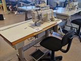 a sewing machine sitting on a table in the middle of a room