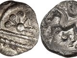 a close up of a silver coin with an image of a man on a horse
