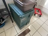 tiled floor in a kitchen with a sink and a trash can
