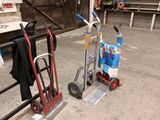 two hand trucks and a cart in a warehouse