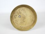 a yellow plate with a hole in it on a white surface