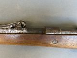 an old gun with a wooden handle on a table