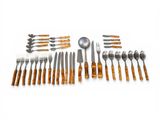 many different types of silverware on a white surface