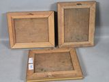 two wooden picture frames with a tag on them sitting next to each other