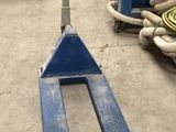 a fork lifter that is sitting in a warehouse
