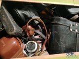 a box full of old suitcases and a camera