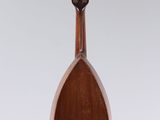 a close up of a wooden mandolin hanging from a string