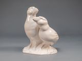 two birds that are standing next to each other on a table