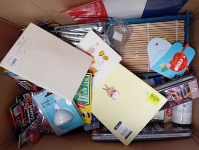 a cardboard box filled with various items and a notepad