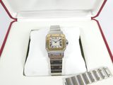 a silver and gold watch in a red box