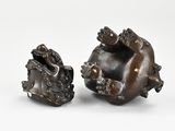 a pair of bronze figurines of a lion and a dog