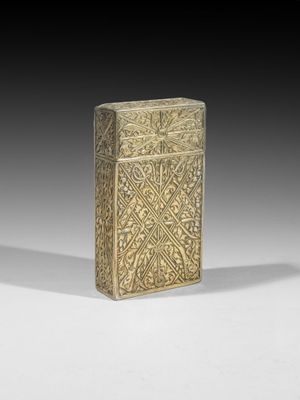 an old brass cigarette case with a design on the front