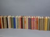 several books are stacked on top of each other on a table