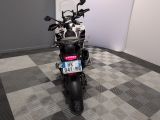 a motorcycle that is parked on a checkered floor