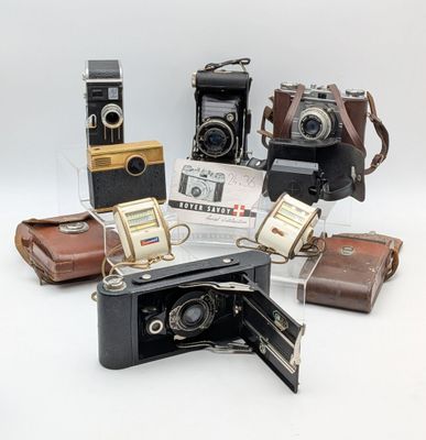 many different types of cameras sitting on a white surface