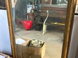 a mirror that is sitting on the floor next to a box of boxes
