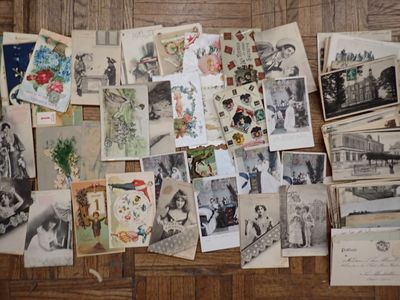 a lot of old photos on the floor of this room