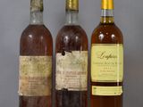 three bottles of wine sitting on a table next to each other