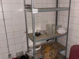 a dirty room with shelves and a chair in it