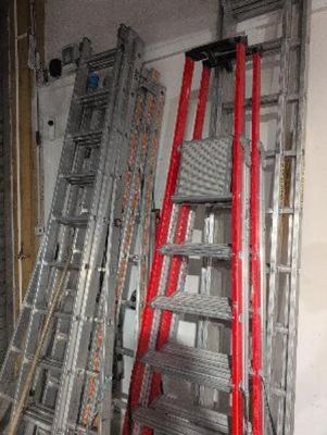 many ladders that are stacked up in a room