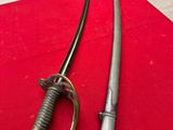 two swords on a red table with a chair in the background