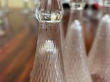 several clear glass bottles sitting on top of a wooden table