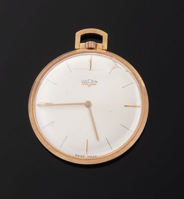 a close up of a gold watch with a white face on a black surface