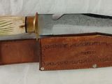 a knife that is laying on top of a leather sheath