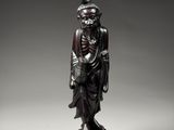 a bronze figure of a man holding a bird on a pedestal
