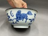 a hand that is holding a bowl with a horse on it