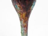 a glass vase that is sitting on a white surface