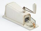 a small white sewing machine that is on a white surface