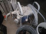 several buckets of water and hoses sitting next to a radiator