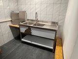 a kitchen with a sink and a stove in it
