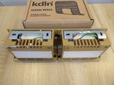 pair of gold and white power transformers sitting on top of a wooden table