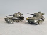 two toy tanks sitting side by side on a table