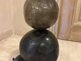 three balls stacked on top of each other on the floor