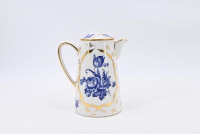 a small blue and white pitcher with a gold rim