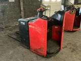 two red and black forklifts in a warehouse