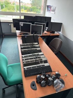a desk with a bunch of computer monitors on it