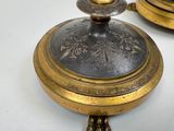 a gold plate with a clock on it sitting on a table