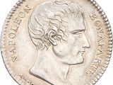 a close up of a coin with a man ' s face on it