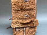 a small brown bag with a fur inside of it