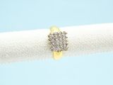 a yellow gold and diamond ring on a white napkin