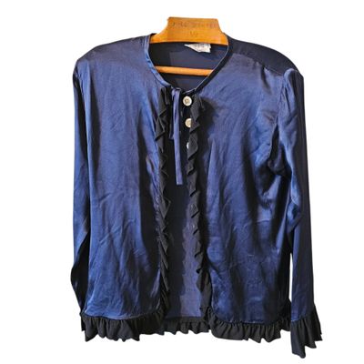 blue blouse with ruffles and buttons on a hanger
