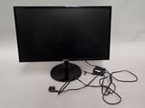 a computer monitor and a charger sitting on a table