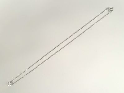 silver plated chain with a single diamond on a white background
