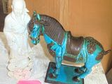 a statue of a horse and a statue of a man on a table